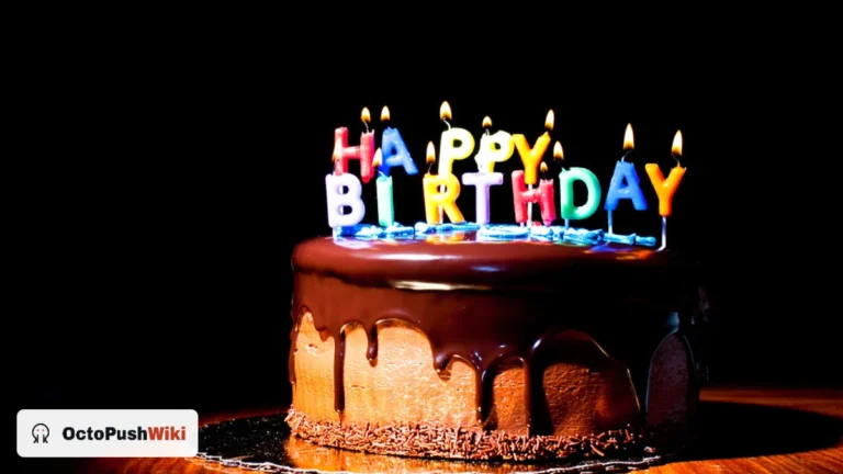 Chocolate cake with lit happy birthday candles, for happy birthday wishes for WhatsApp