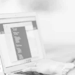 Person typing on a laptop, illustrating LLM meaning and AI language models