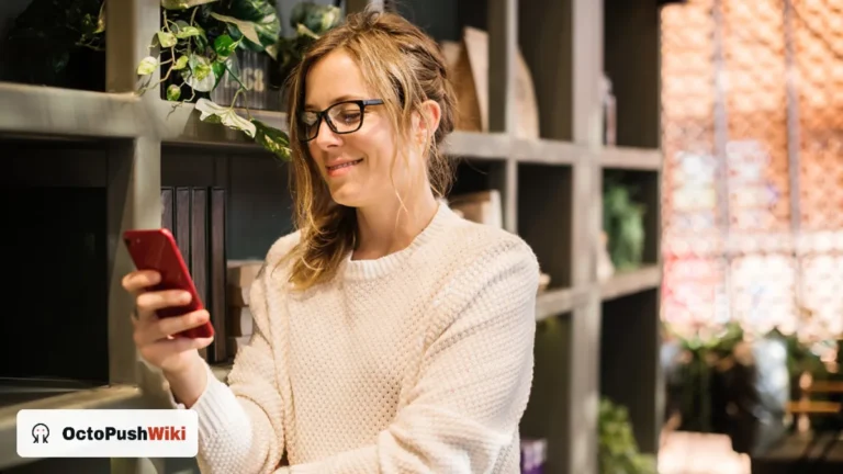 Woman smiling while reading a text message, illustrating OFC meaning in text