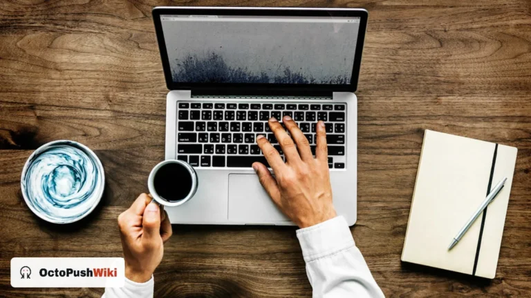 Person typing on a laptop at a wooden desk while reading a blog such as pushwiki com