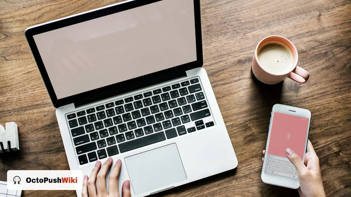 Laptop and smartphone on a wooden desk, illustrating a snapjotz com website review