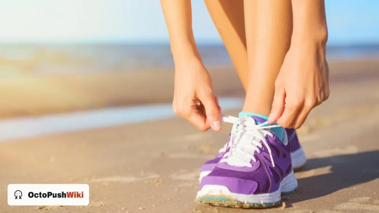 Woman tying purple running shoes on a beach before a workout, an activity suited to the women's Under Armour Tech Twist half zip
