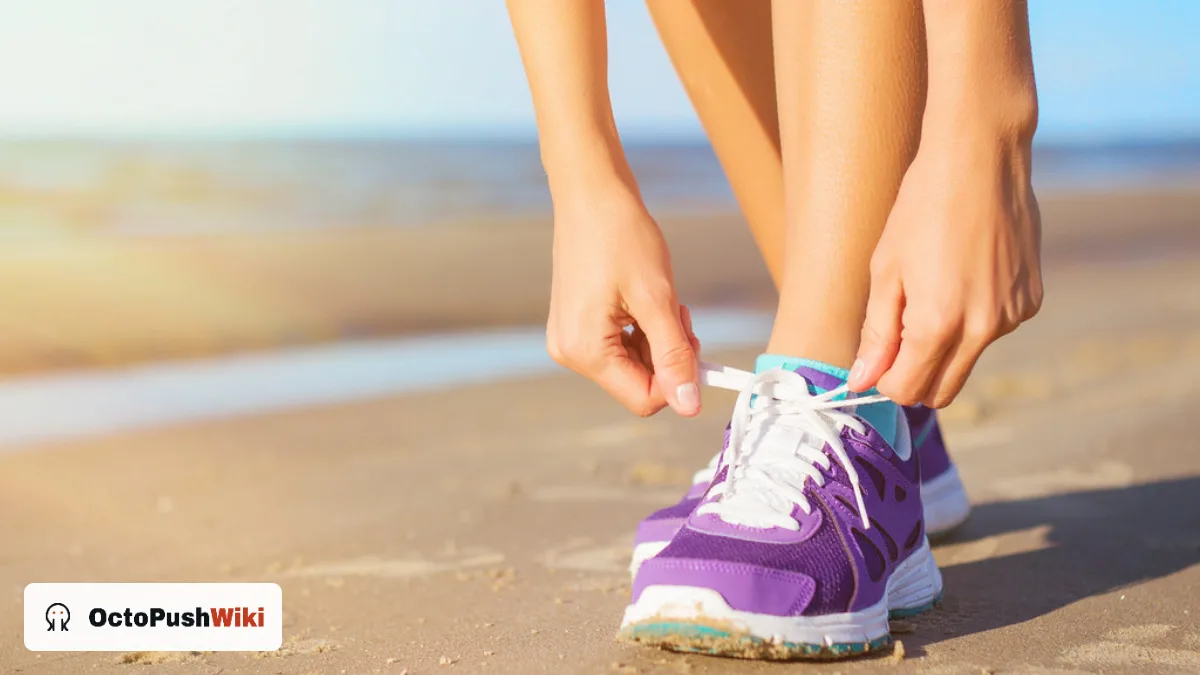 Woman tying purple running shoes on a beach before a workout, an activity suited to the women's Under Armour Tech Twist half zip